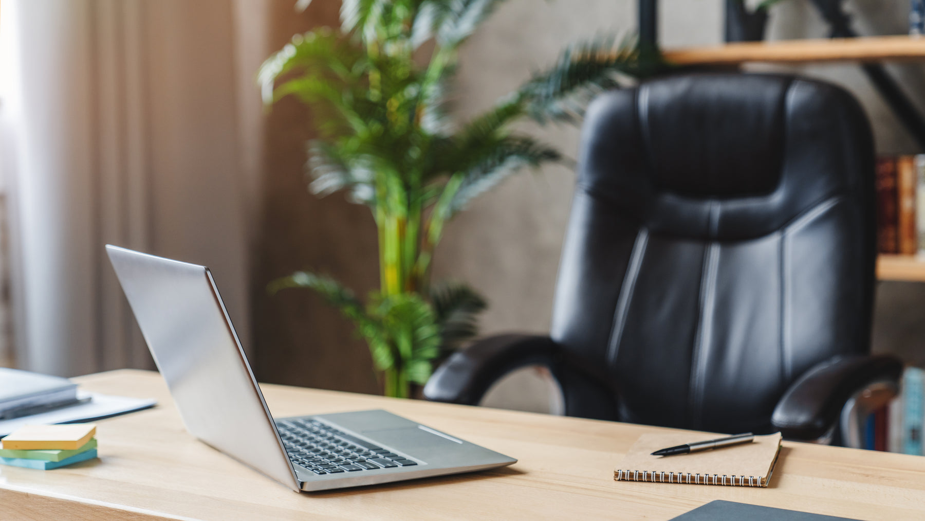 Luxury office chair at desk with laptop.