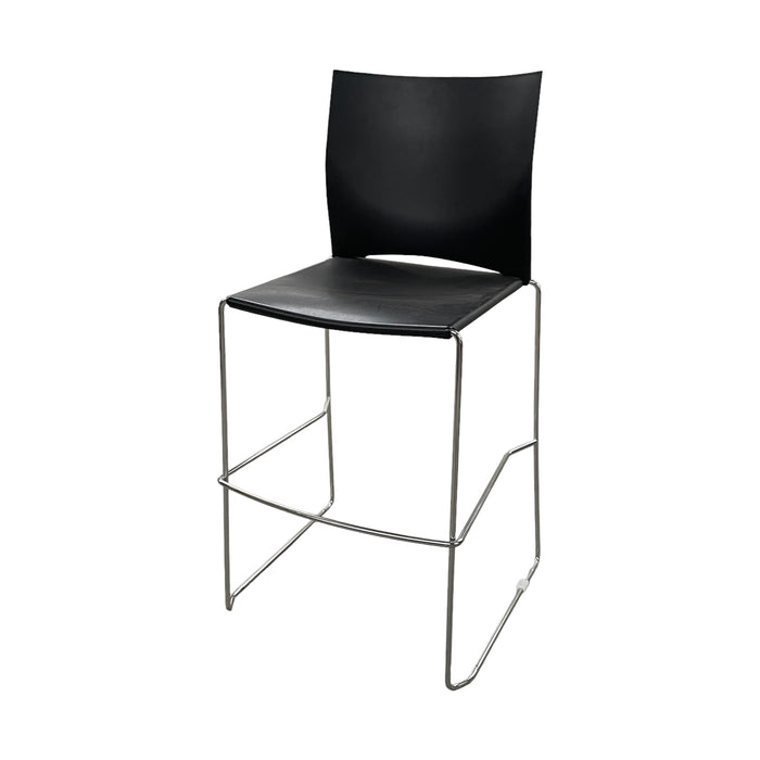 Black Xpresso stacking bar stool with metal legs, and footrest, from the side.