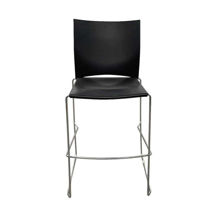 Black Xpresso stacking bar stool with metal legs, and footrest, from the front.