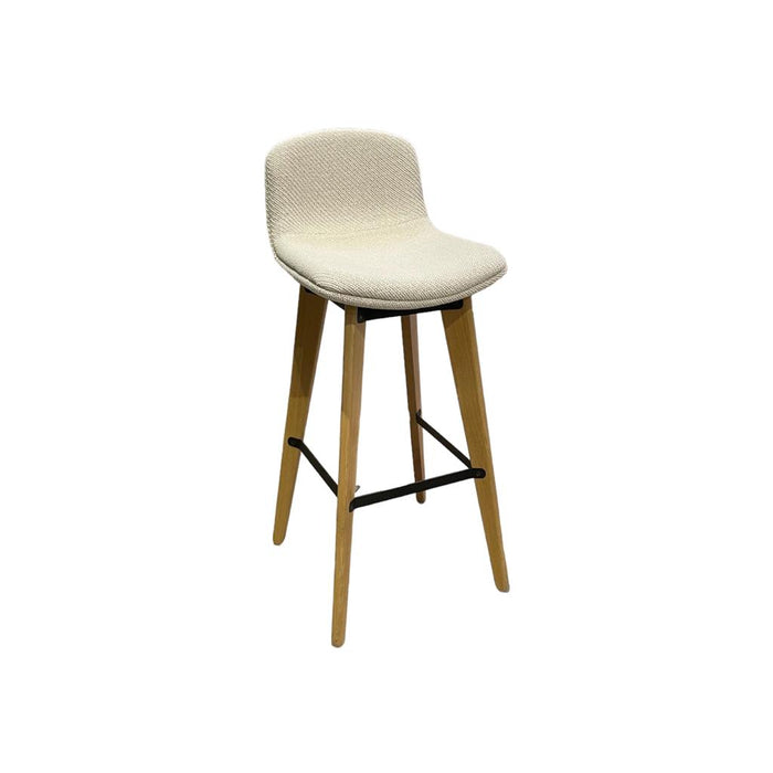 Cream bar stool with knitted upholstery and wooden legs, on an angle. 